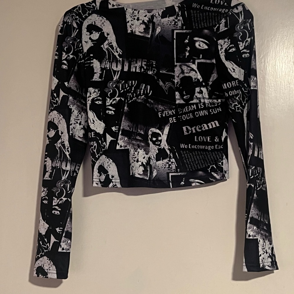 Small black and white reverse newspaper print long sleeve crop top
